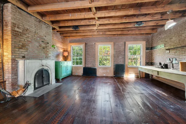 a living room with a fireplace and a wooden floor