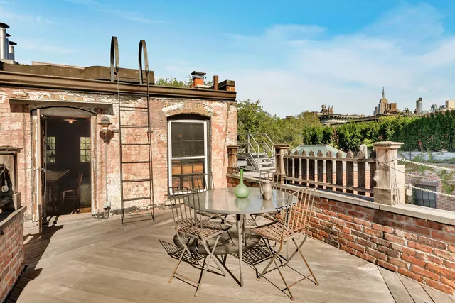 a spacious bedroom with a bed a table and chairs