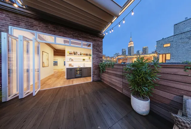 a bedroom with a large bed and windows