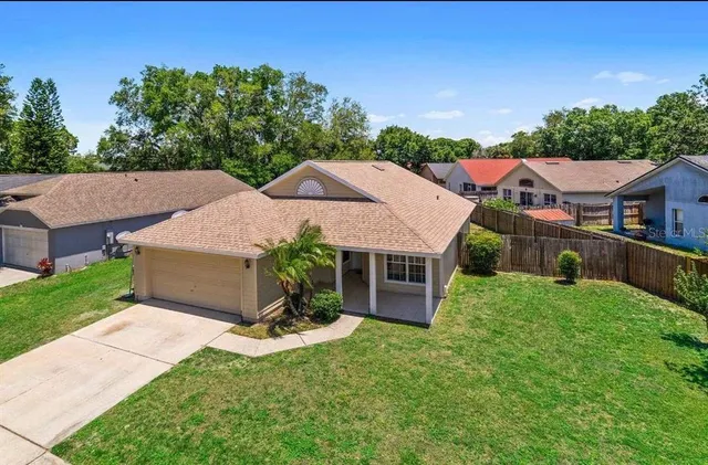 an aerial view of a house with garden space and a street