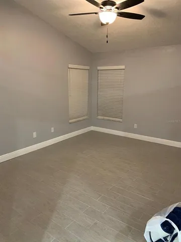 a bathroom with a granite countertop toilet a sink and a mirror