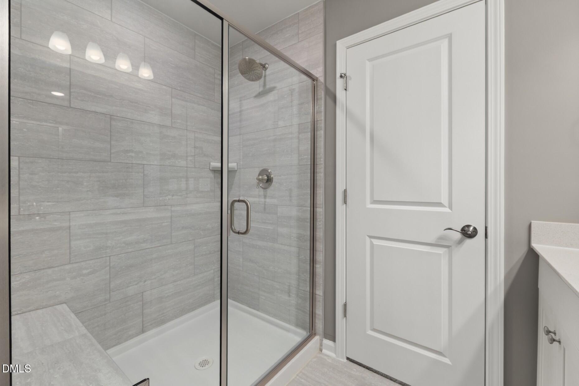 2913 Denson Road Fuquay-Varina, NC 27526 - Photo 13 of 30 a bathroom with a glass shower door