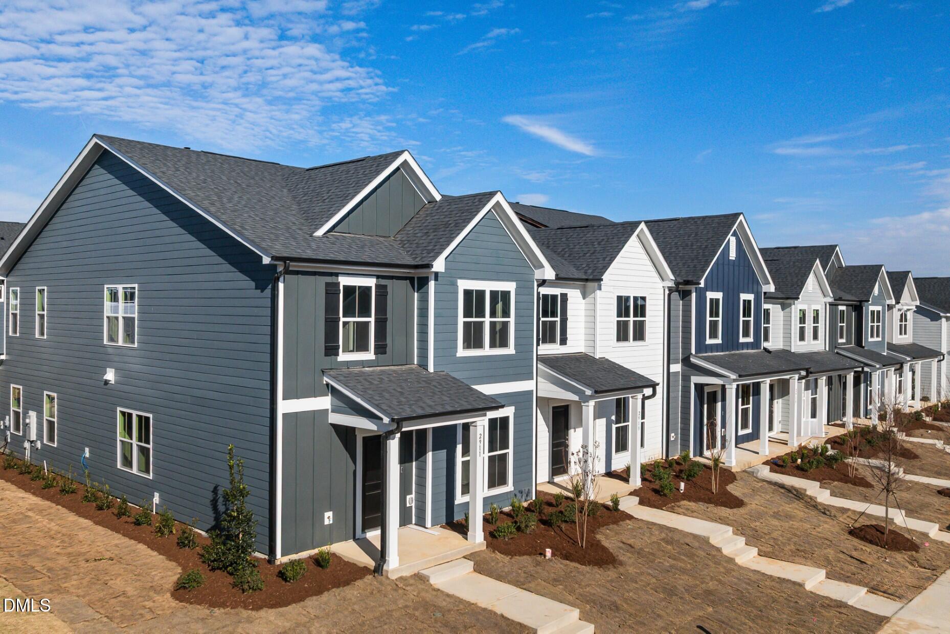 2913 Denson Road Fuquay-Varina, NC 27526 - Photo 25 of 30 a front view of a residential apartment building with a yard