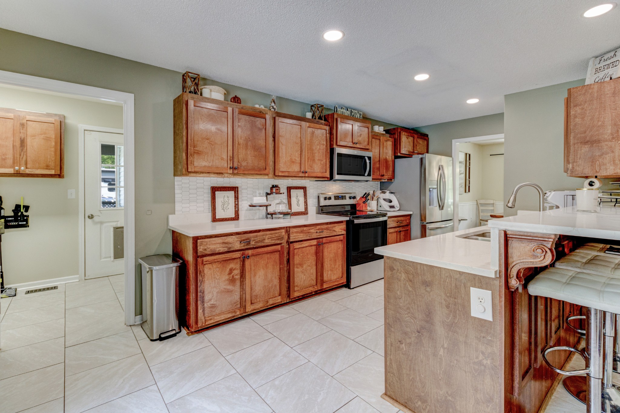 88 Chapel Road Tullahoma, TN 37388 - Photo 11 of 27 a large kitchen with kitchen island a sink a stove a refrigerator and a cabinets