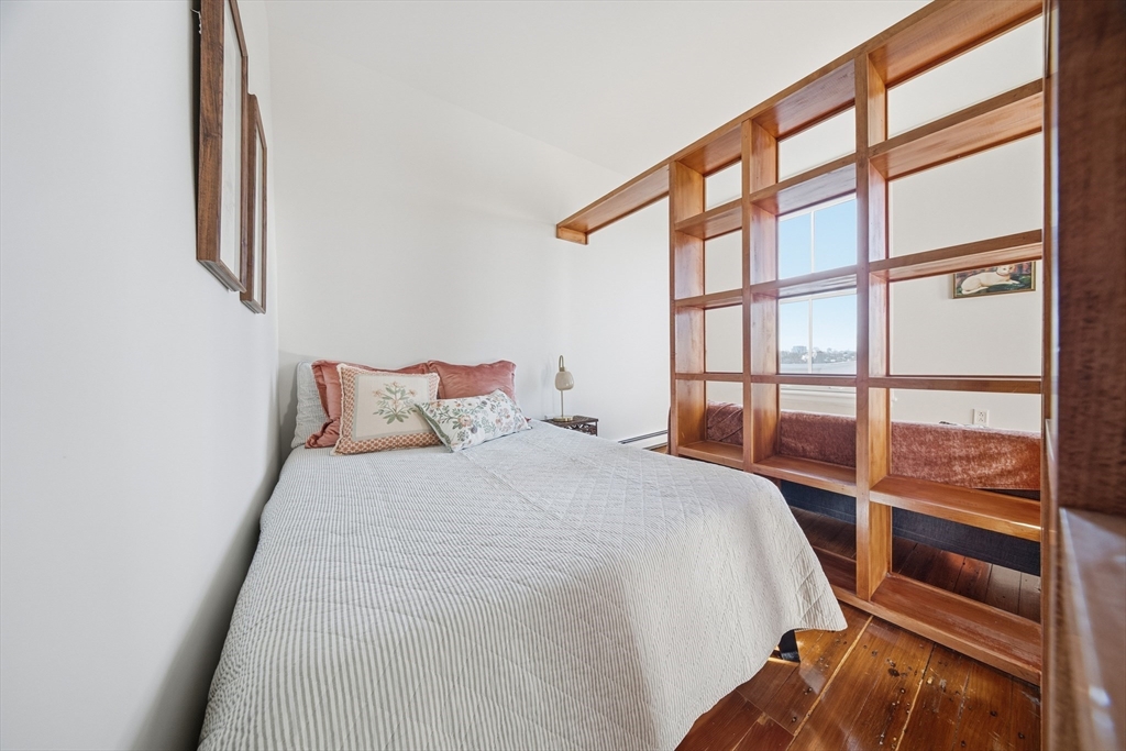 367 Somerville Avenue, Unit G Somerville, MA 02143 - Photo 12 of 39 a large bed sitting in a bedroom next to a window