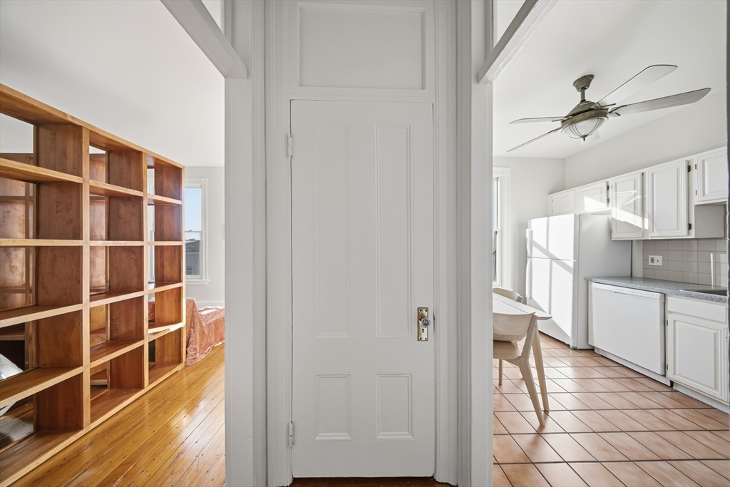 367 Somerville Avenue, Unit G Somerville, MA 02143 - Photo 14 of 39 a view of a kitchen with wooden floor and a window