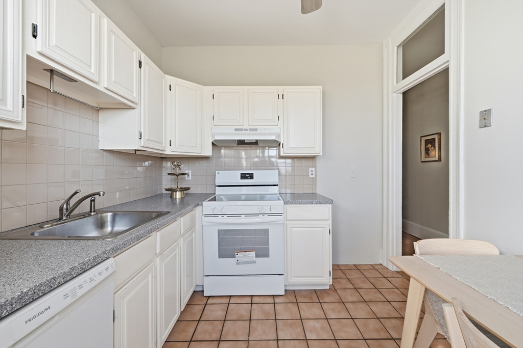 367 Somerville Avenue, Unit G Somerville, MA 02143 - Photo 21 of 39 a kitchen with a sink stove and cabinets