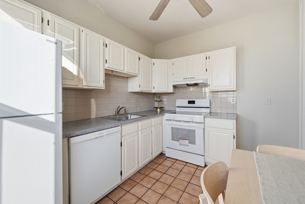 367 Somerville Avenue, Unit G Somerville, MA 02143 - Photo 22 of 39 a kitchen with cabinets appliances a sink and a counter top space