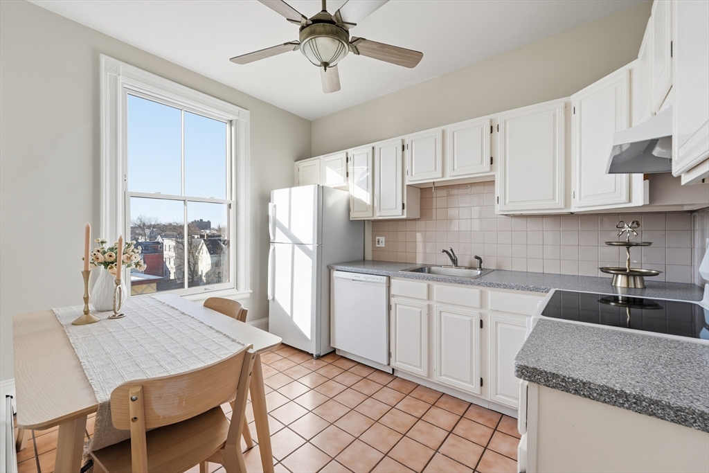 367 Somerville Avenue, Unit G Somerville, MA 02143 - Photo 23 of 39 a kitchen with a sink a refrigerator and cabinets