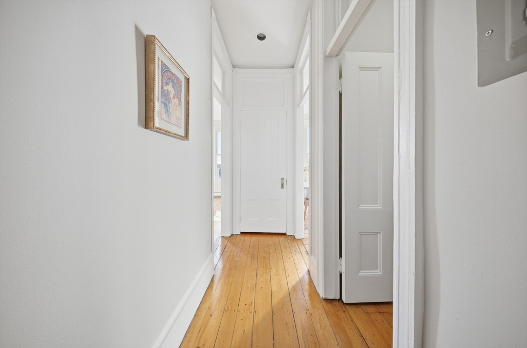 367 Somerville Avenue, Unit G Somerville, MA 02143 - Photo 25 of 39 a view of a hallway with wooden floor and a bathroom