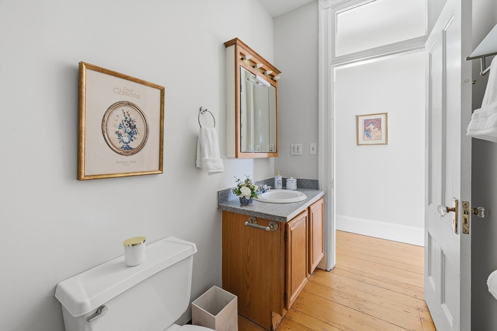 367 Somerville Avenue, Unit G Somerville, MA 02143 - Photo 27 of 39 a bathroom with a toilet a sink and a mirror