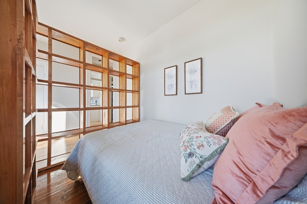 367 Somerville Avenue, Unit G Somerville, MA 02143 - Photo 10 of 39 a bed sitting in a bedroom next to a window