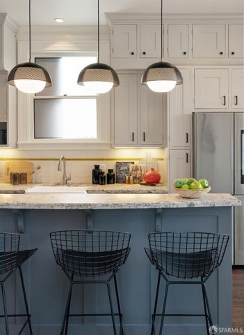 a kitchen with stainless steel appliances granite countertop a sink a stove and a refrigerator