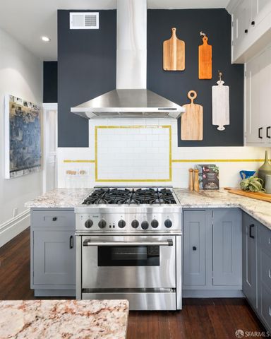a stove top oven sitting inside of a kitchen
