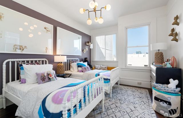 a bedroom with 2 bed and a window