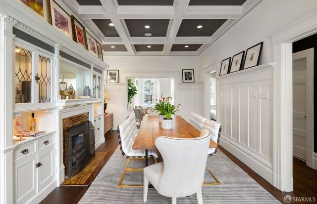 a living room with furniture a fireplace and a chandelier