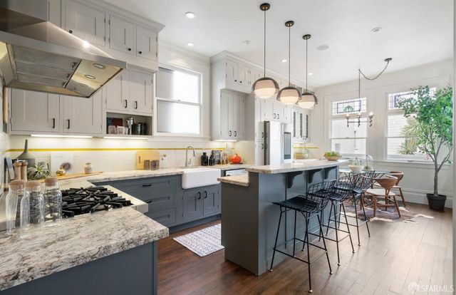 a large kitchen with lots of counter space and stainless steel appliances