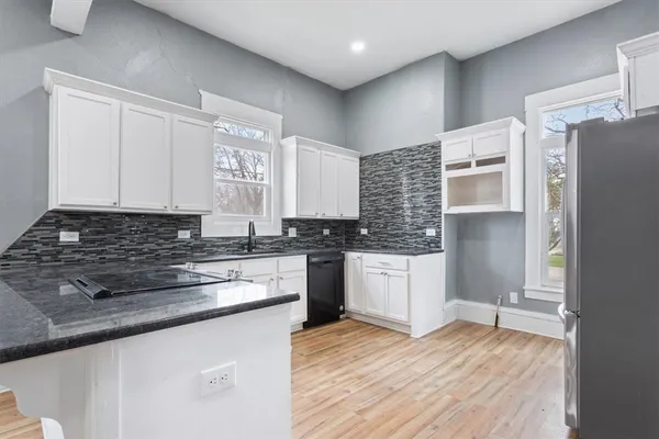 a kitchen with a refrigerator and a sink