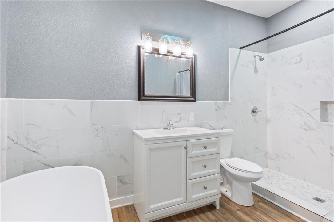 2000 Bosque Boulevard Waco, TX 76707 - Photo 21 of 51 a bathroom with a toilet sink and mirror