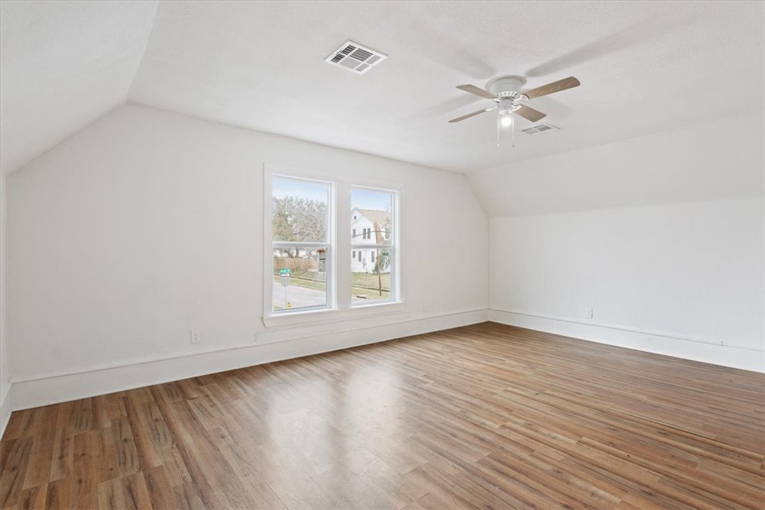 2000 Bosque Boulevard Waco, TX 76707 - Photo 23 of 51 an empty room with wooden floor fan and windows