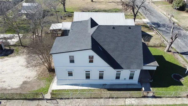 an aerial view of a house with a yard and staircase
