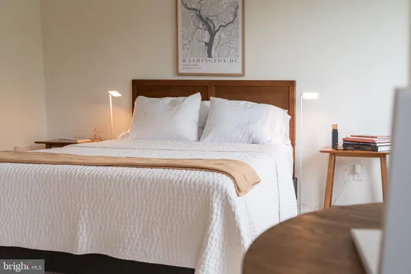 a bedroom with a bed and a night stand