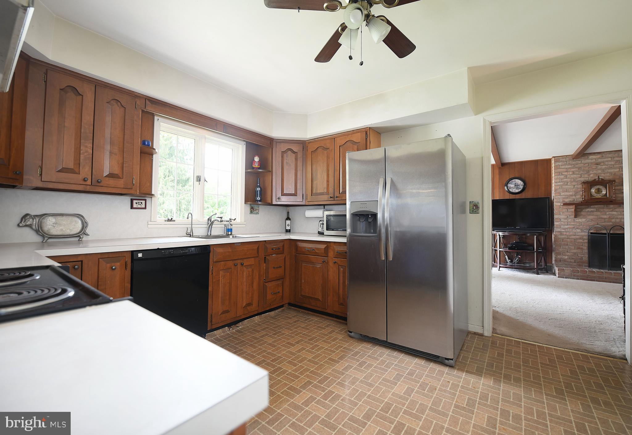1303 Old Fallston Road Fallston, MD 21047 - Photo 25 of 65 a kitchen with stainless steel appliances granite countertop a sink a stove a refrigerator cabinets and a dining table