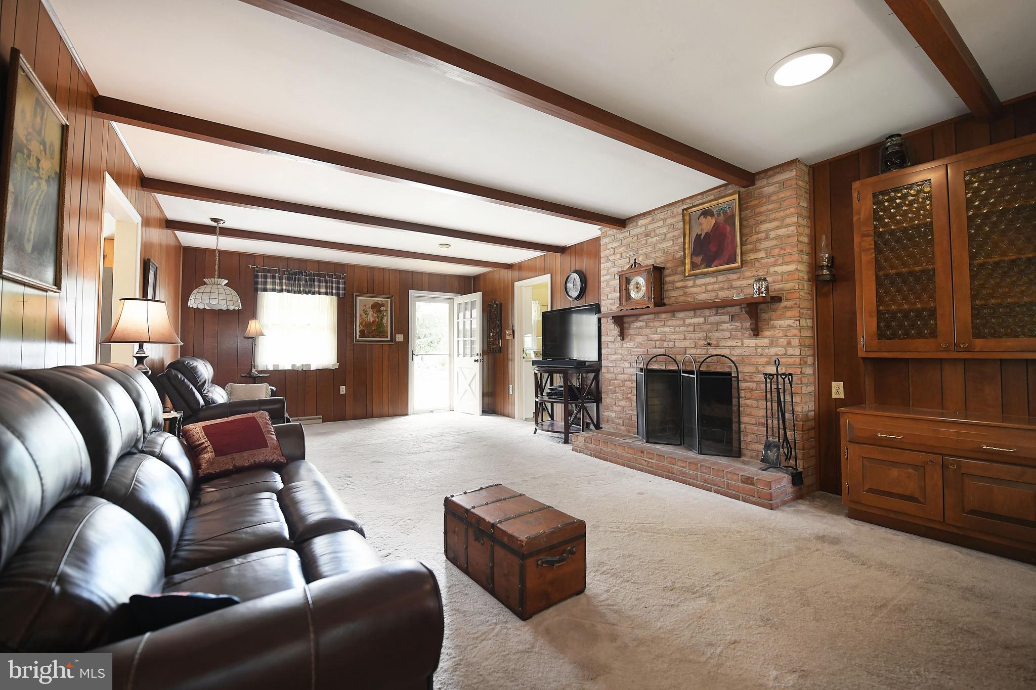 1303 Old Fallston Road Fallston, MD 21047 - Photo 27 of 65 a living room with furniture a flat screen tv and a fireplace