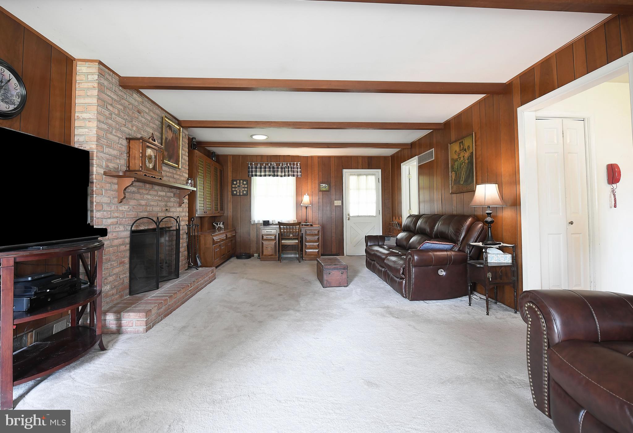 1303 Old Fallston Road Fallston, MD 21047 - Photo 28 of 65 a living room with furniture a flat screen tv and a fireplace