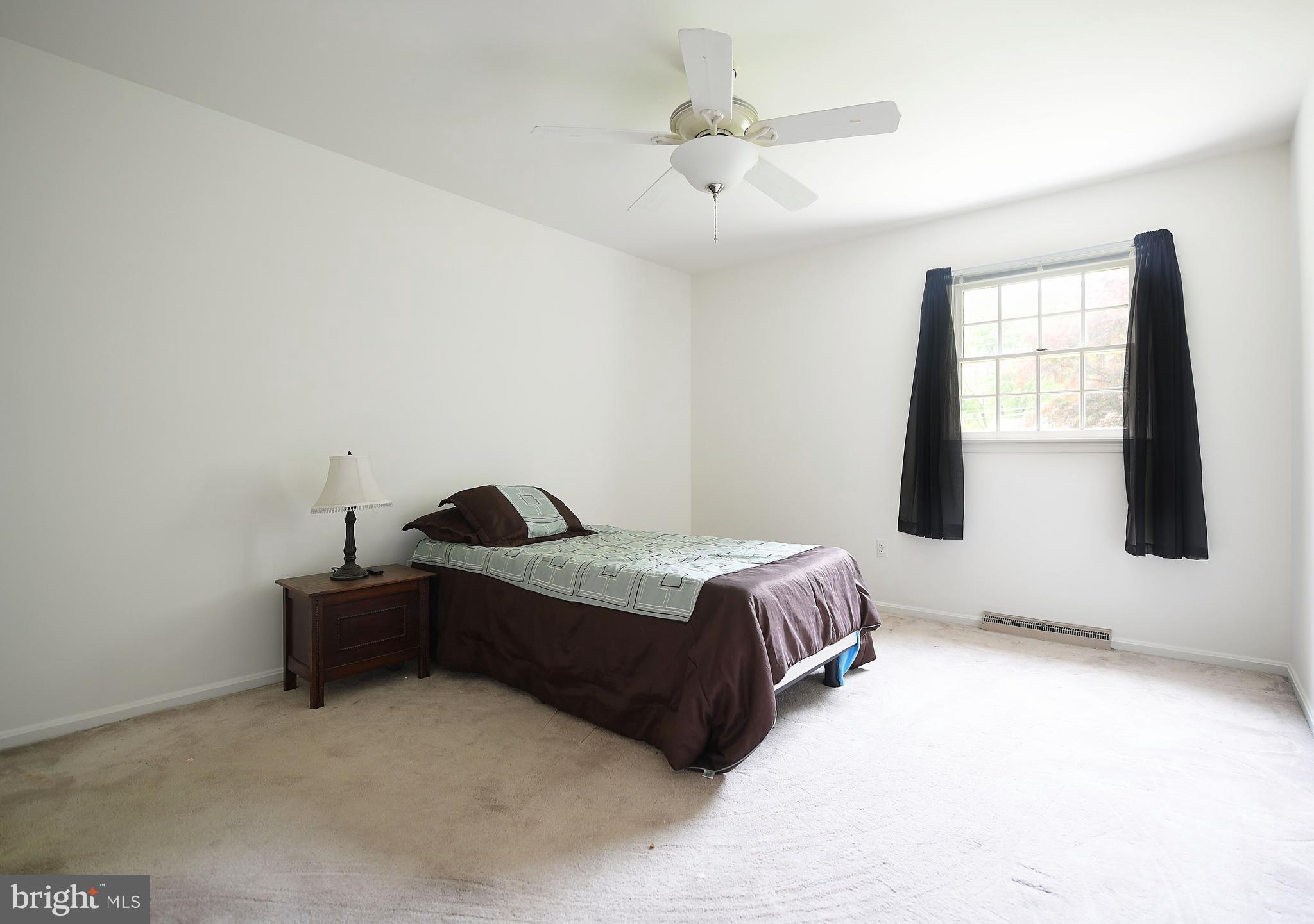 1303 Old Fallston Road Fallston, MD 21047 - Photo 34 of 65 a spacious bedroom with a bed and a chandelier
