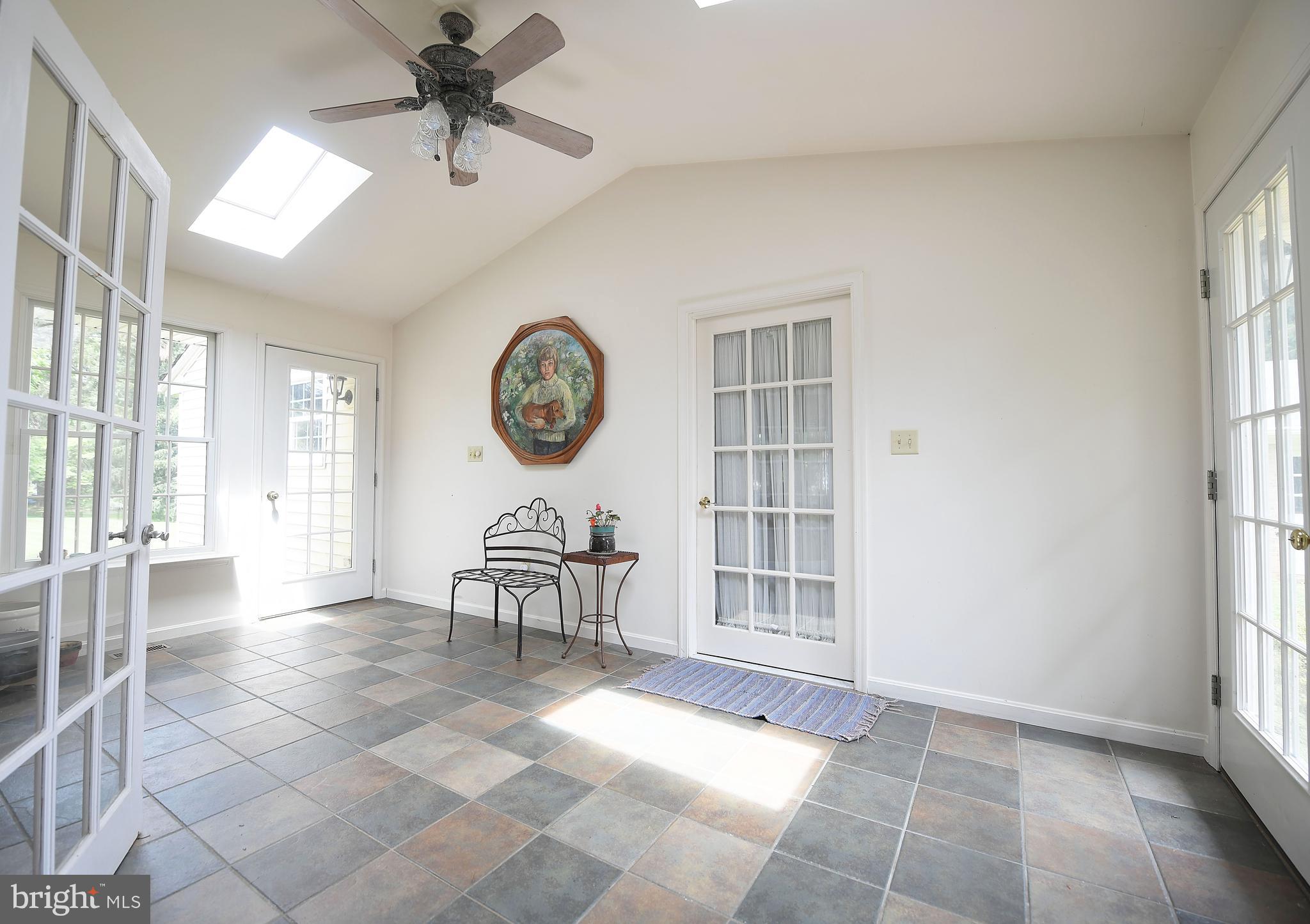 1303 Old Fallston Road Fallston, MD 21047 - Photo 43 of 65 a view of a livingroom with a dinning area hardwood floor and a ceiling fan
