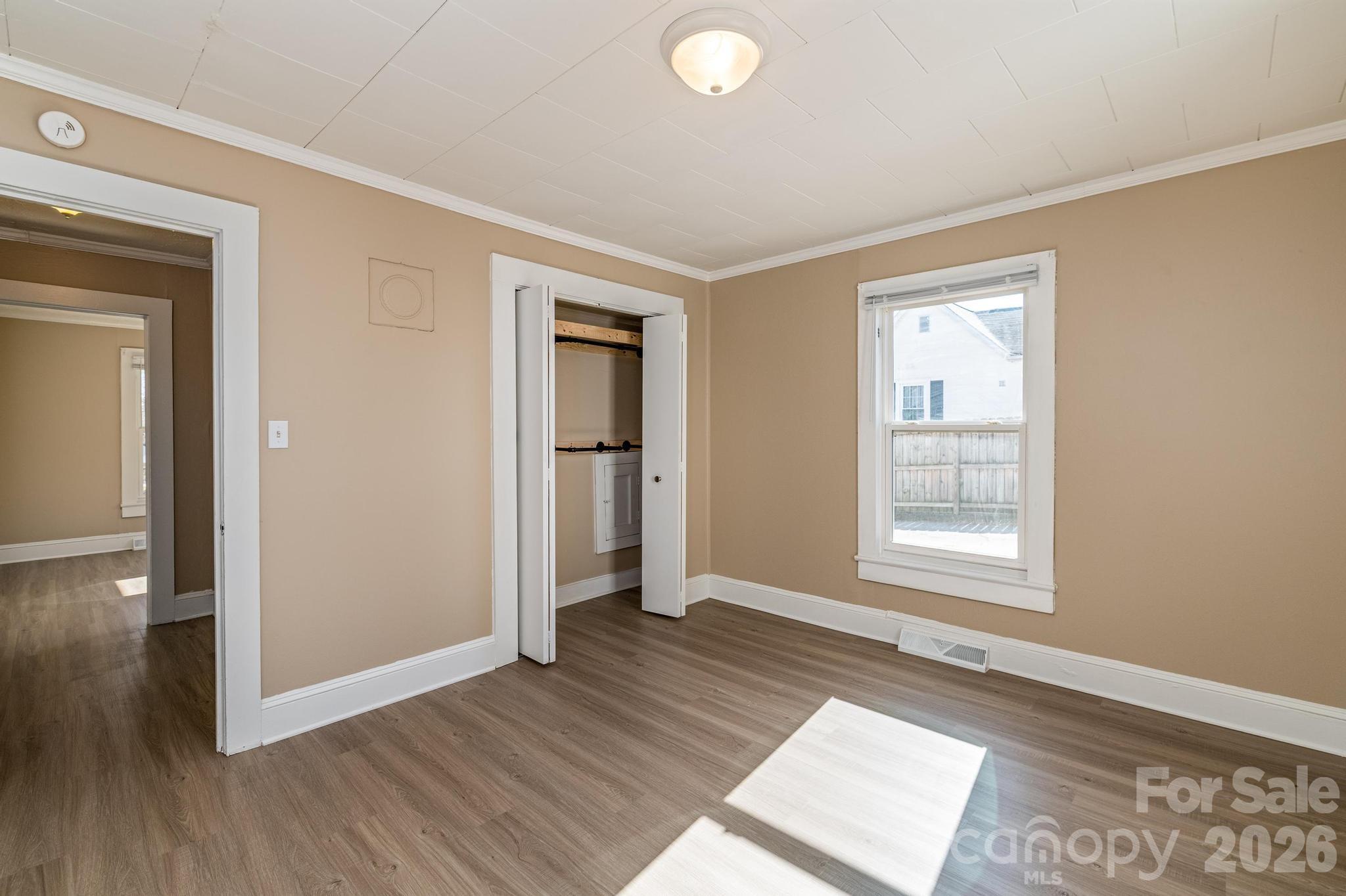 569 Hunter Avenue Kannapolis, NC 28083 - Photo 11 of 20 an empty room with wooden floor and windows