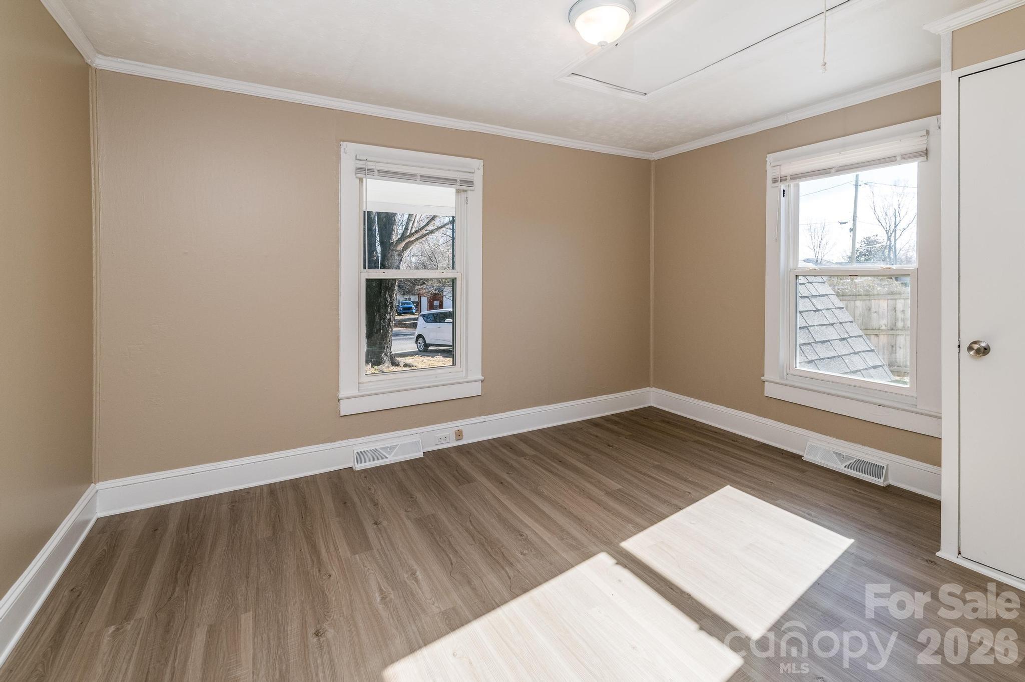 569 Hunter Avenue Kannapolis, NC 28083 - Photo 14 of 20 an empty room with wooden floor and windows