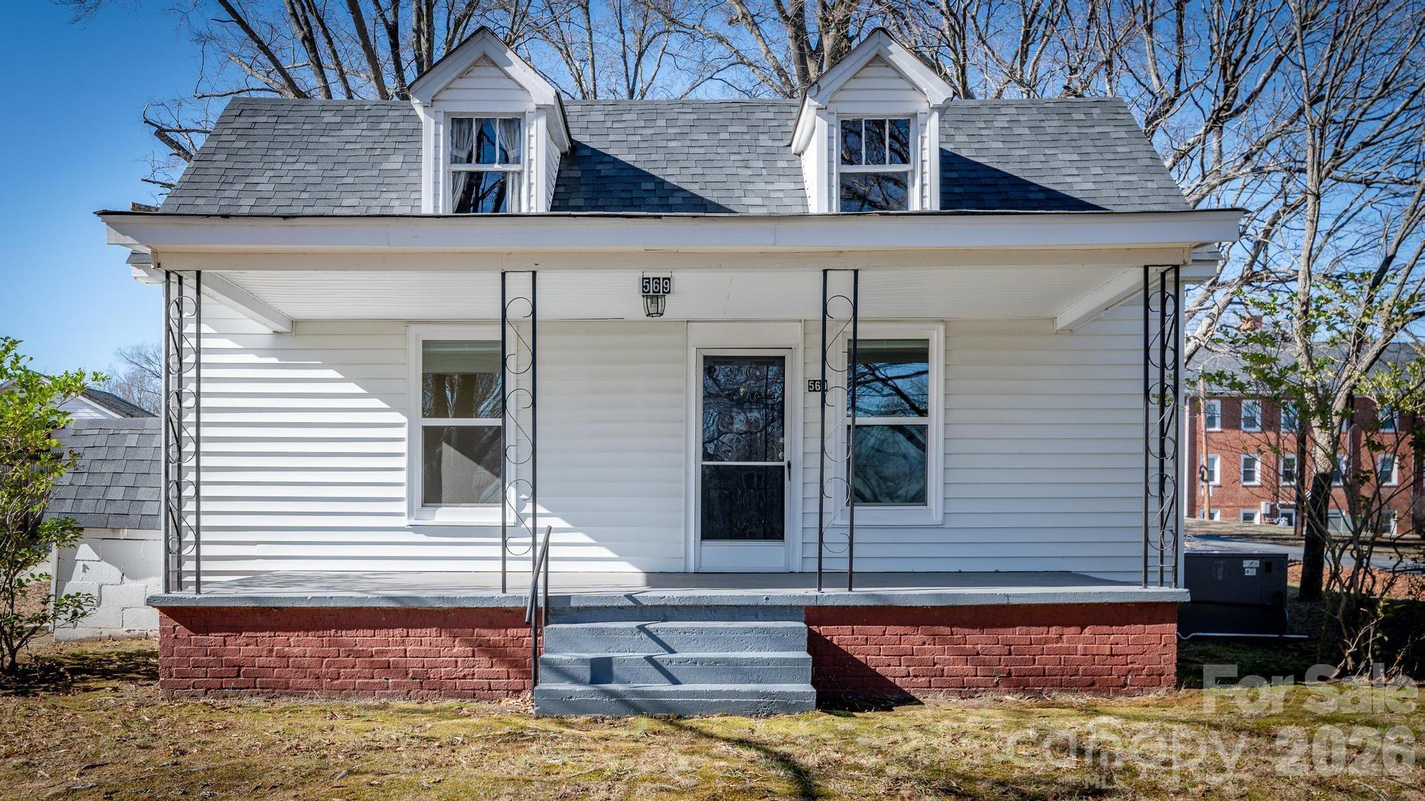 569 Hunter Avenue Kannapolis, NC 28083 - Photo 2 of 20 a view of a white house with many windows