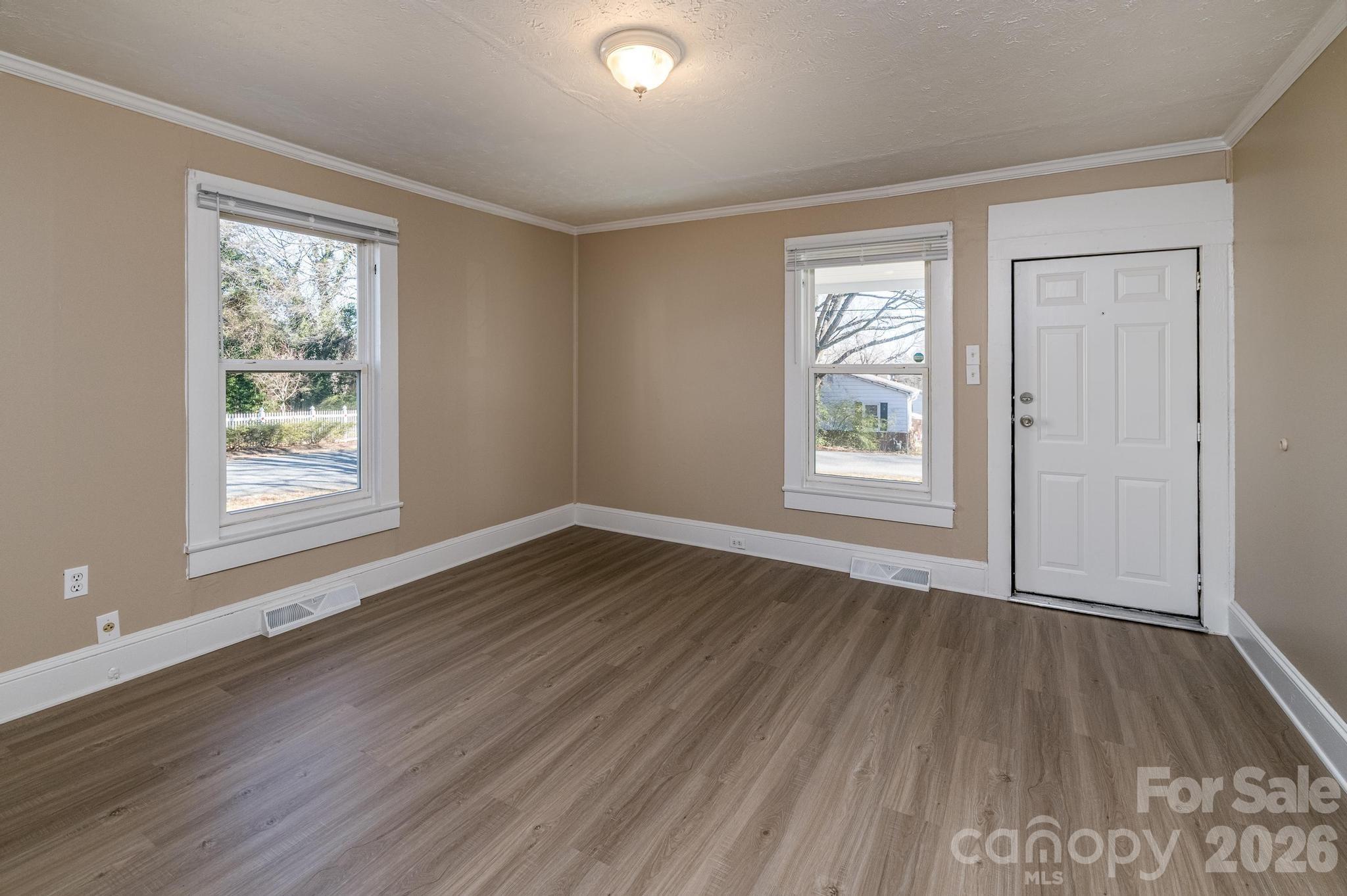 569 Hunter Avenue Kannapolis, NC 28083 - Photo 4 of 20 a view of an empty room with wooden floor and a window