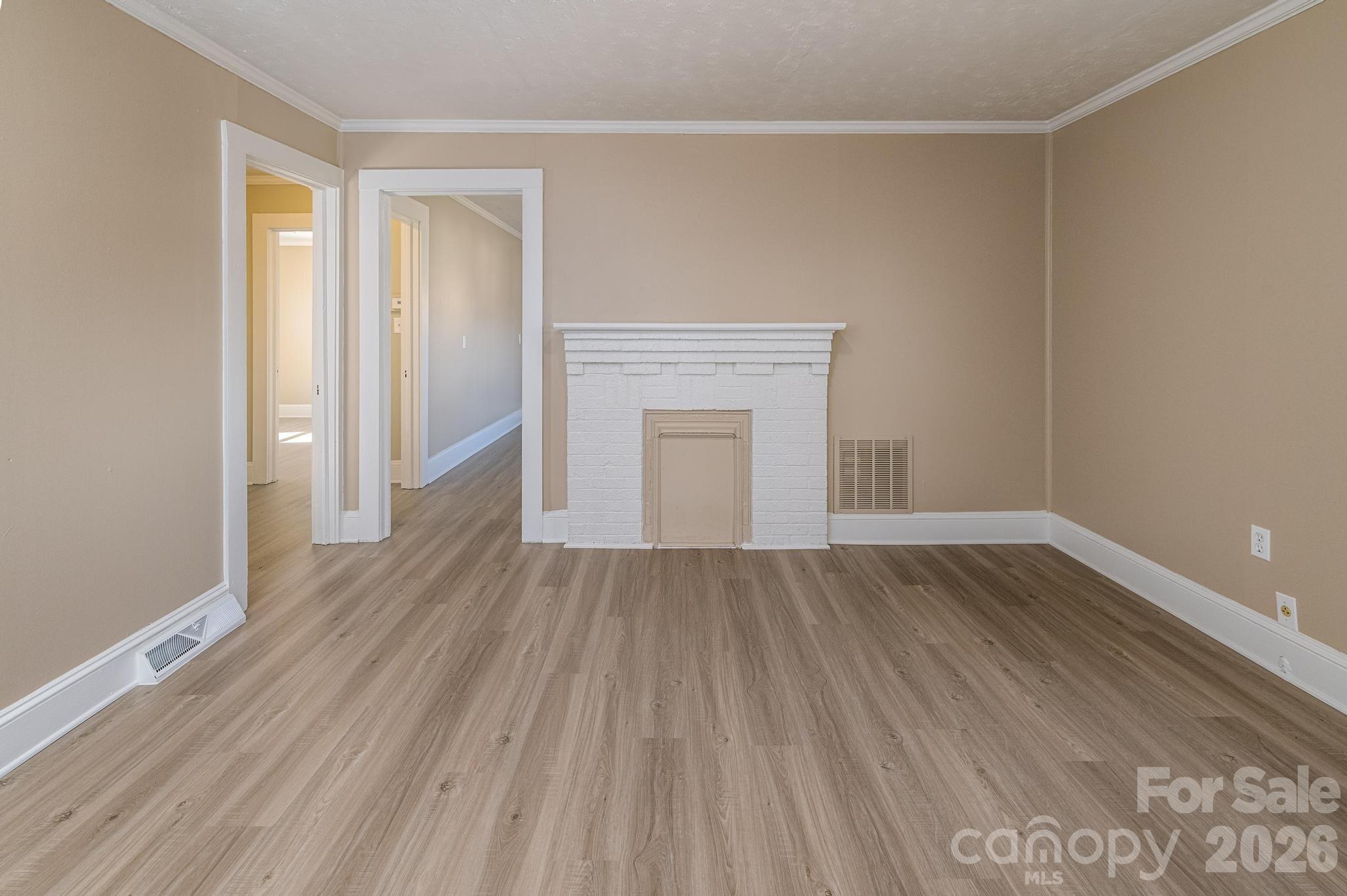569 Hunter Avenue Kannapolis, NC 28083 - Photo 5 of 20 a view of an empty room with wooden floor and a window