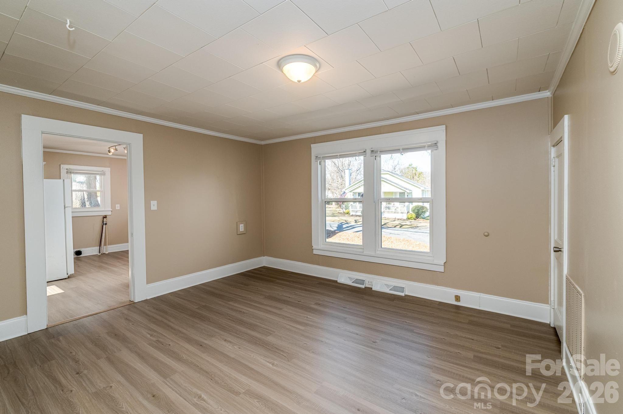 569 Hunter Avenue Kannapolis, NC 28083 - Photo 6 of 20 a view of an empty room with wooden floor and a window
