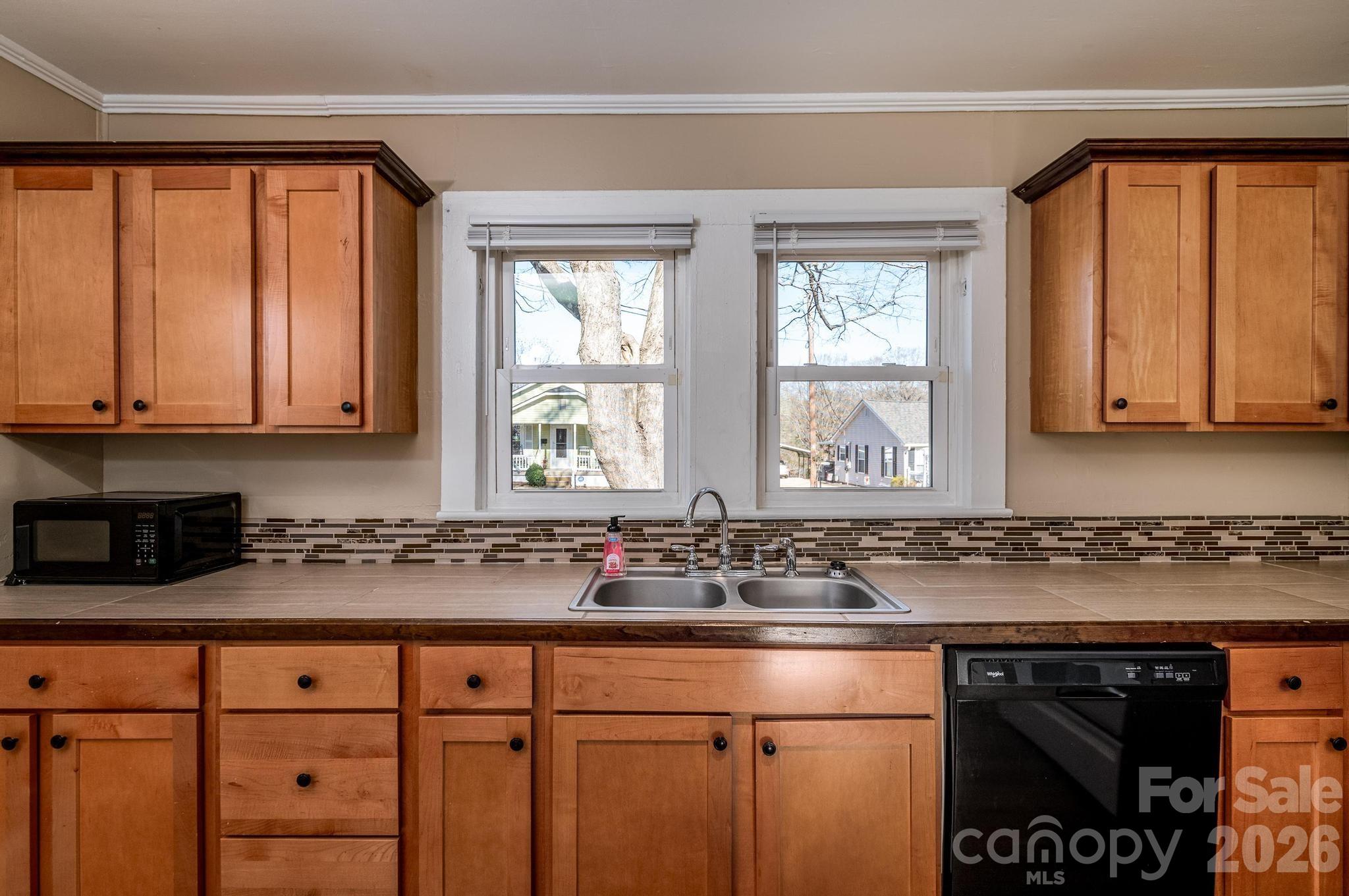 569 Hunter Avenue Kannapolis, NC 28083 - Photo 7 of 20 a kitchen with stainless steel appliances granite countertop a sink a stove and cabinets