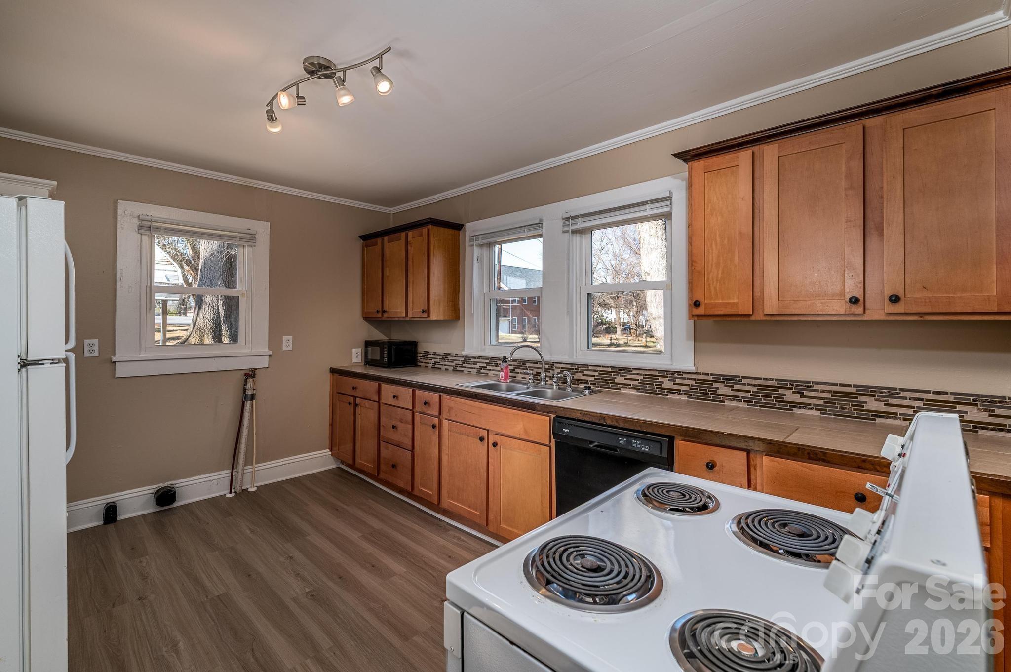569 Hunter Avenue Kannapolis, NC 28083 - Photo 8 of 20 a kitchen with a stove a sink and a microwave