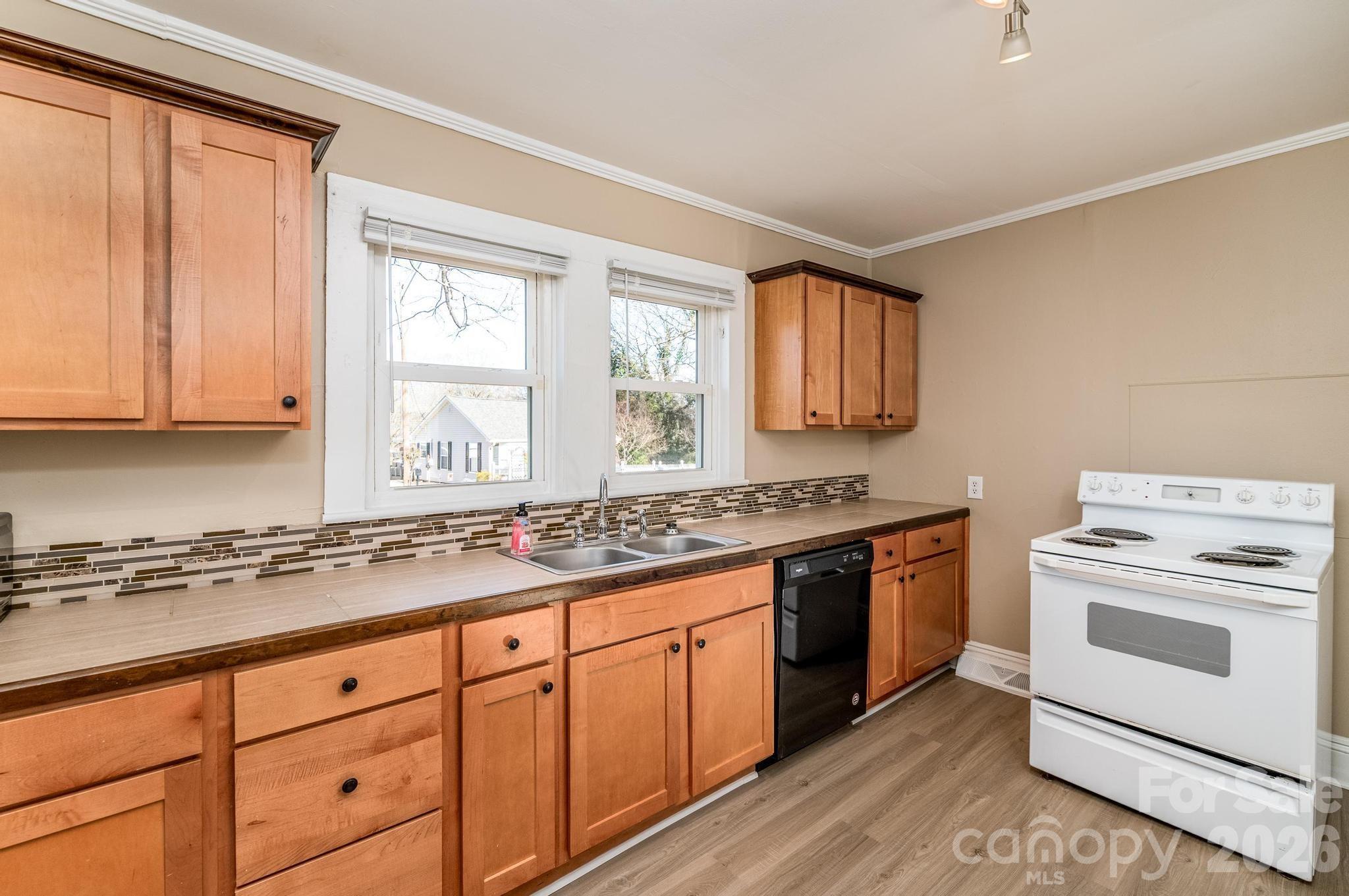 569 Hunter Avenue Kannapolis, NC 28083 - Photo 9 of 20 a kitchen with granite countertop cabinets stainless steel appliances a sink and a window