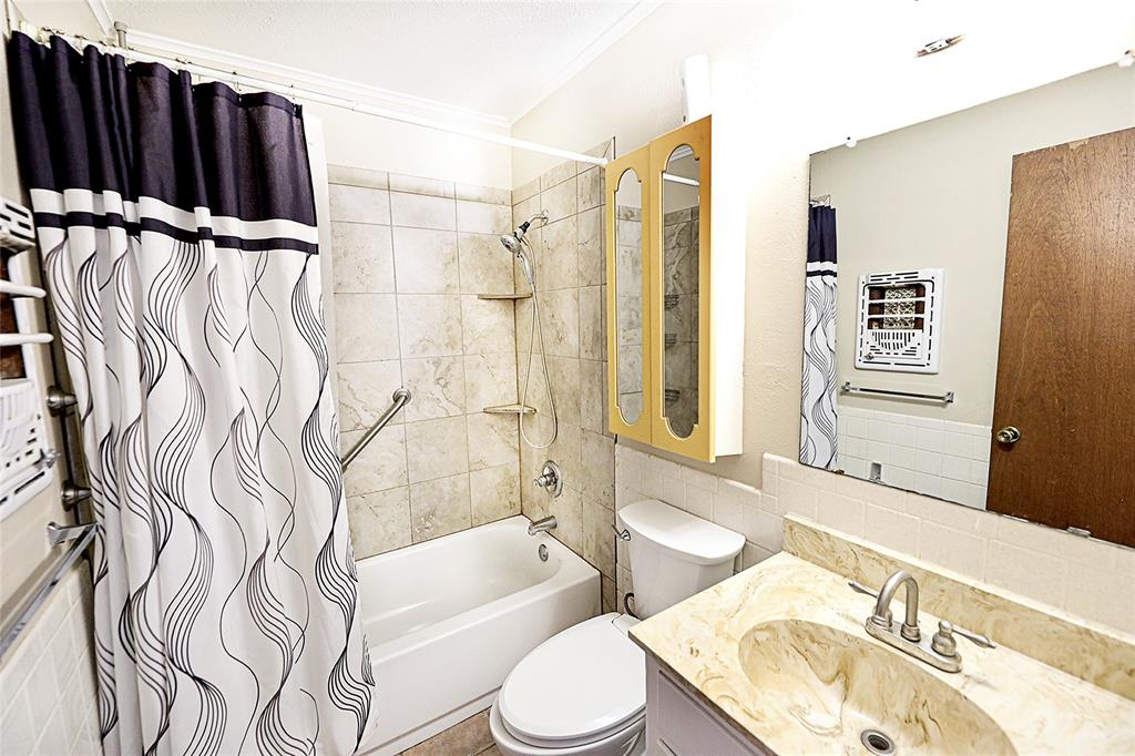 702 Decatur Street Bowie, TX 76230 - Photo 20 of 36 a bathroom with a sink toilet and shower