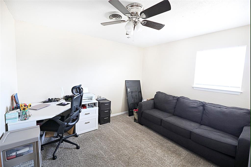 702 Decatur Street Bowie, TX 76230 - Photo 23 of 36 a work room with furniture and a window