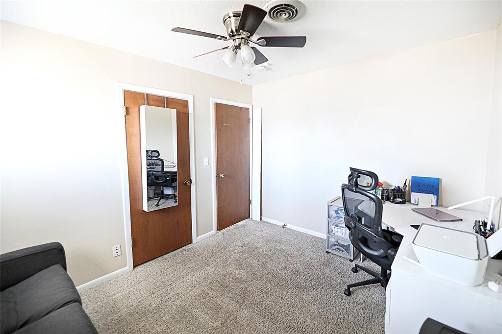 702 Decatur Street Bowie, TX 76230 - Photo 24 of 36 a bedroom with a bed and a chandelier