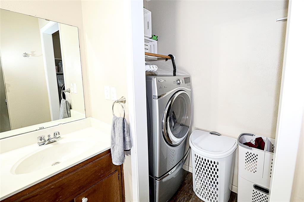702 Decatur Street Bowie, TX 76230 - Photo 28 of 36 a bathroom with a sink and a mirror