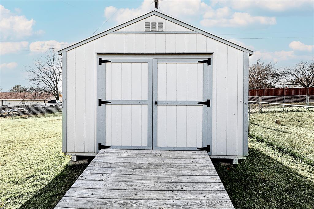 702 Decatur Street Bowie, TX 76230 - Photo 30 of 36 a front view of a house with a yard