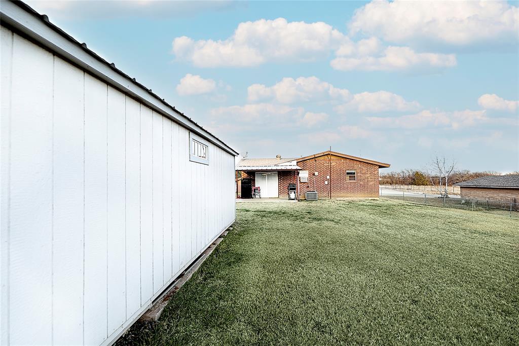 702 Decatur Street Bowie, TX 76230 - Photo 32 of 36 a view of a back yard of the house