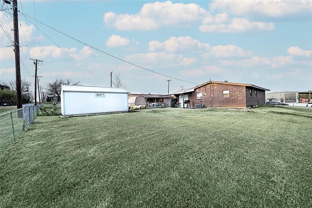 702 Decatur Street Bowie, TX 76230 - Photo 33 of 36 a view of a house with a yard and sitting area