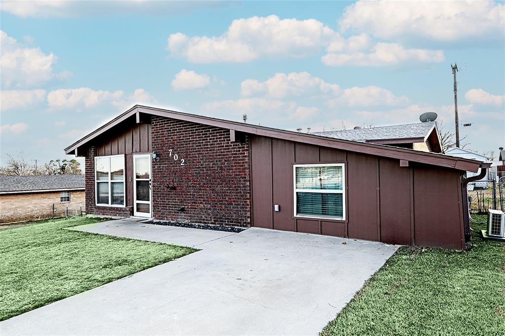702 Decatur Street Bowie, TX 76230 - Photo 5 of 36 a front view of a house with garden
