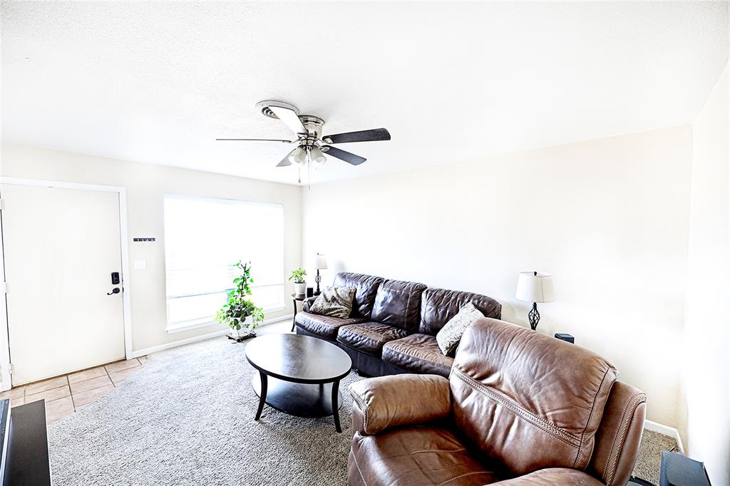 702 Decatur Street Bowie, TX 76230 - Photo 7 of 36 a living room with furniture and a potted plant