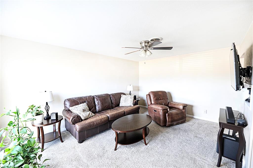 702 Decatur Street Bowie, TX 76230 - Photo 8 of 36 a living room with furniture and a ceiling fan